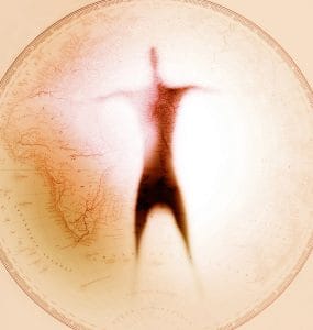 Person in shadow in from of a map