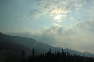 Sun shining through the clouds over mountains